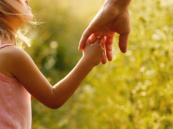 Child Support image of daughter holding father's hand