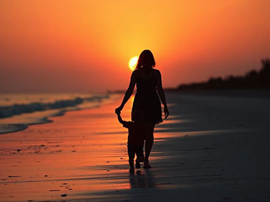 Paternity image of woman and child on beach